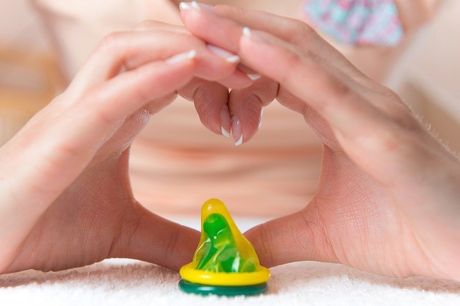 Condom in heart doing by womans hand