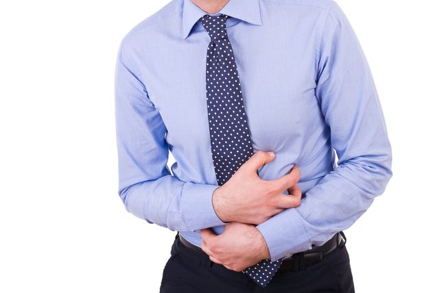 Businessman suffering from stomach pain.